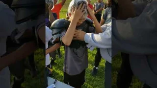 Trying on the football shoulder pads